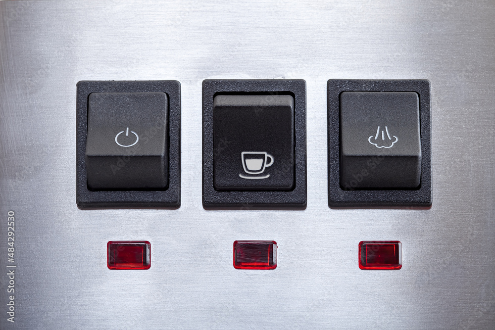 Black coffee brew button with drink cup symbol, close-up of panel with black plastic buttons for espresso coffee machine and heat steam for milk frothing. Black coffee brew button with drink cup symbol, close-up of panel with black plastic buttons for espresso coffee machine and heat steam for milk frothing.