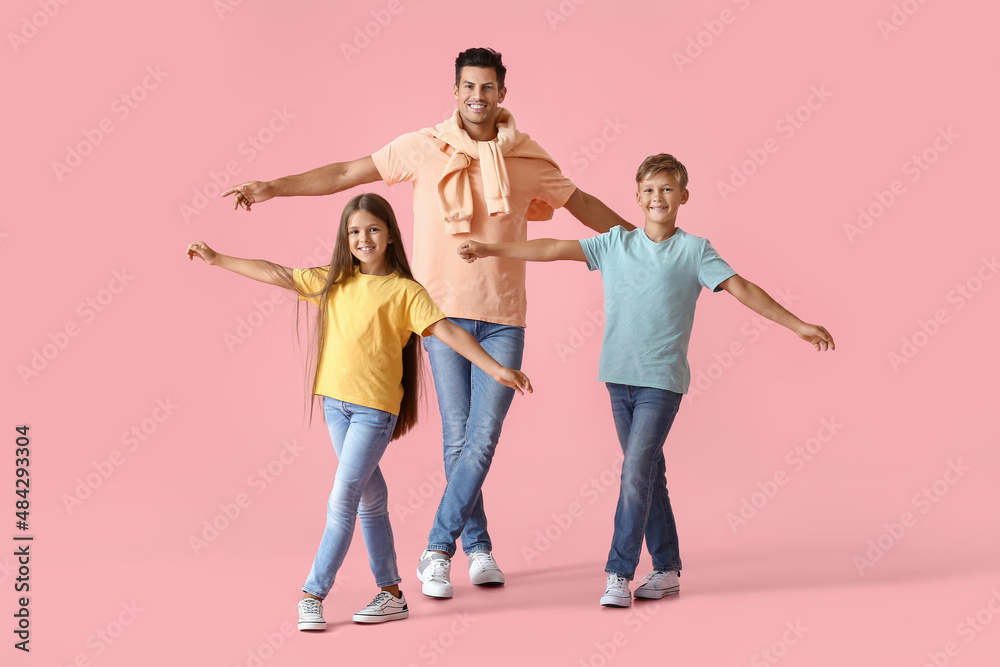 Happy dancing man and his children on color background Happy dancing man and his children on color background