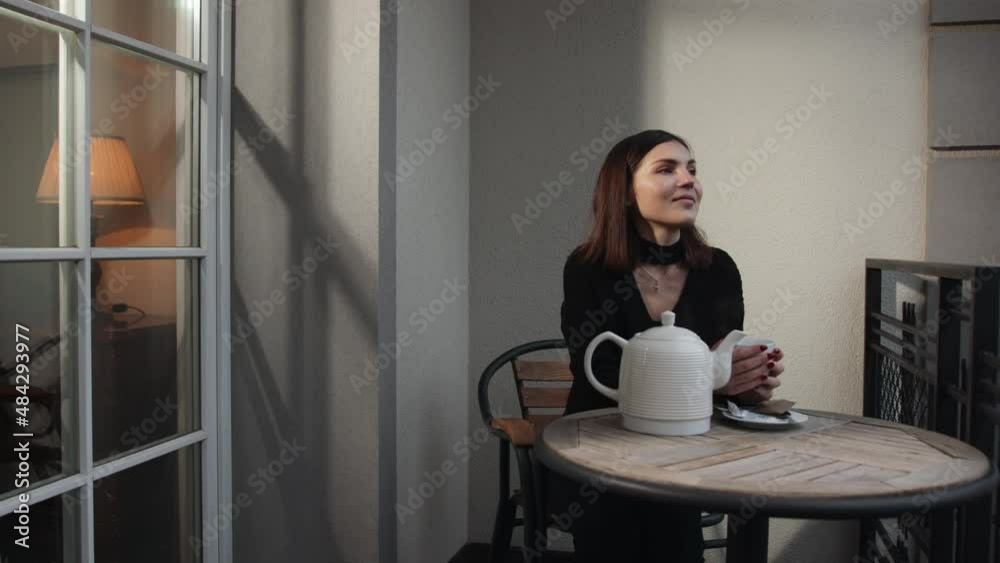 Happy dreamy young ethnic woman rest on balcony enjoy warm coffee look Happy dreamy young ethnic woman rest on balcony enjoy warm coffee look