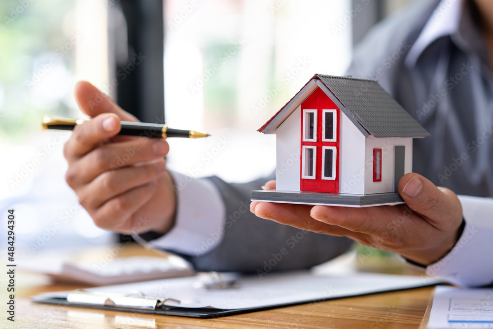 Real estate agents offer prices. and model homes, handing out keys