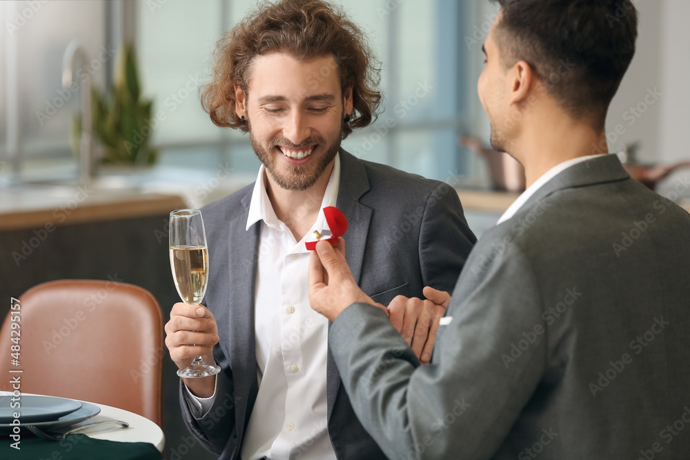 Young gay proposing to his boyfriend on romantic date Young gay proposing to his boyfriend on romantic date