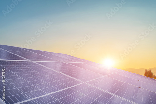 solar panels against sunset sky background. Photovoltaic, alternative electricity source. sustainable resources concept.