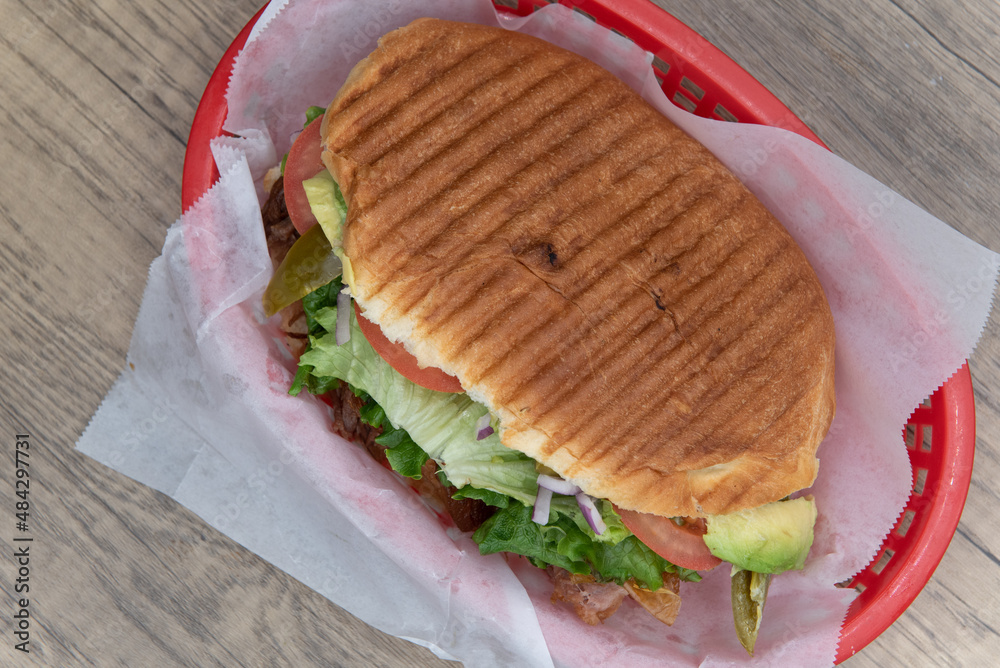 Overhead view of enormous carnitas torta sandwich is loaded and