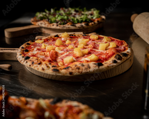 handmade hawaiian pizza with fresh ingredients right out of the oven