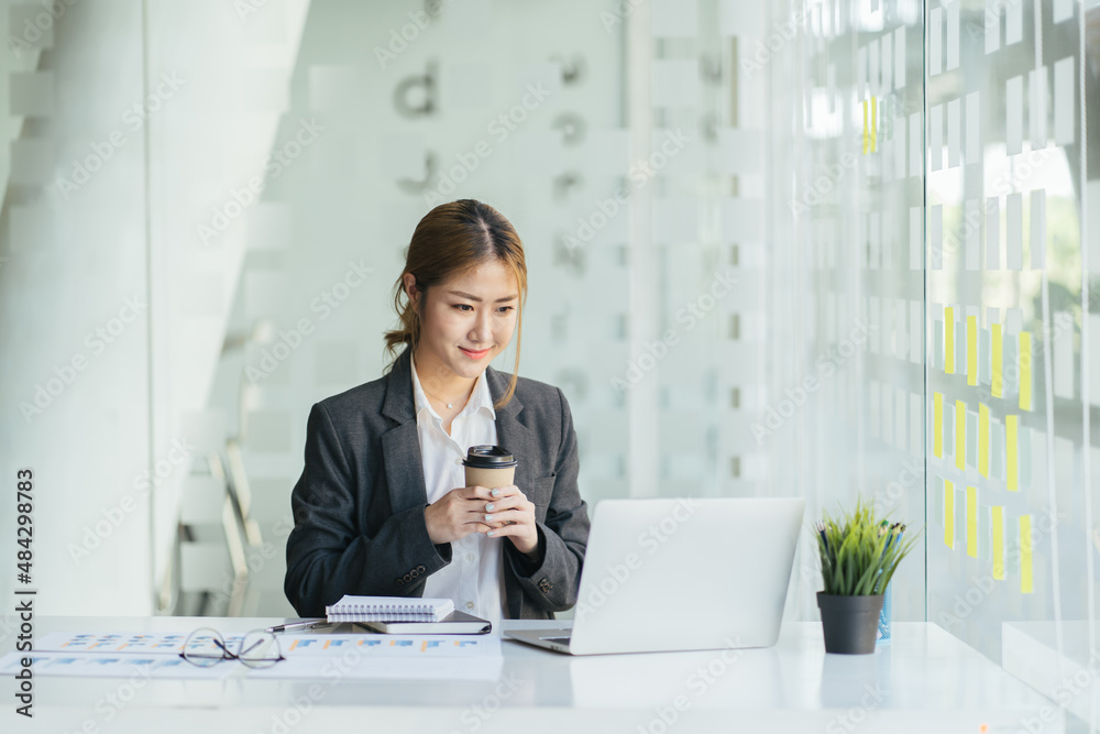 Beautiful asian lady working at modern office, drinking coffee. Beautiful asian lady working at modern office, drinking coffee.