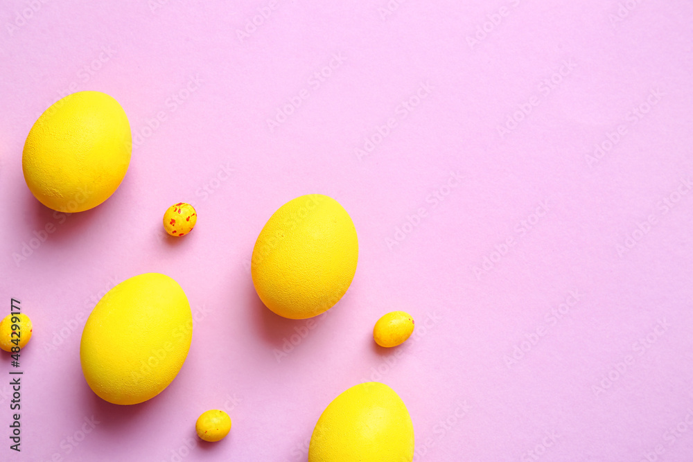 Yellow painted Easter eggs on color background