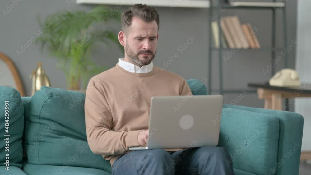 Man with Laptop Thinking on Sofa Man with Laptop Thinking on Sofa