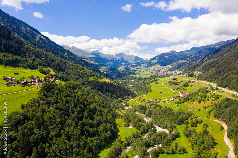 Obraz premium Picturesque summer mountain landscape overlooking small alpine village of Cavardiras, Switzerland
