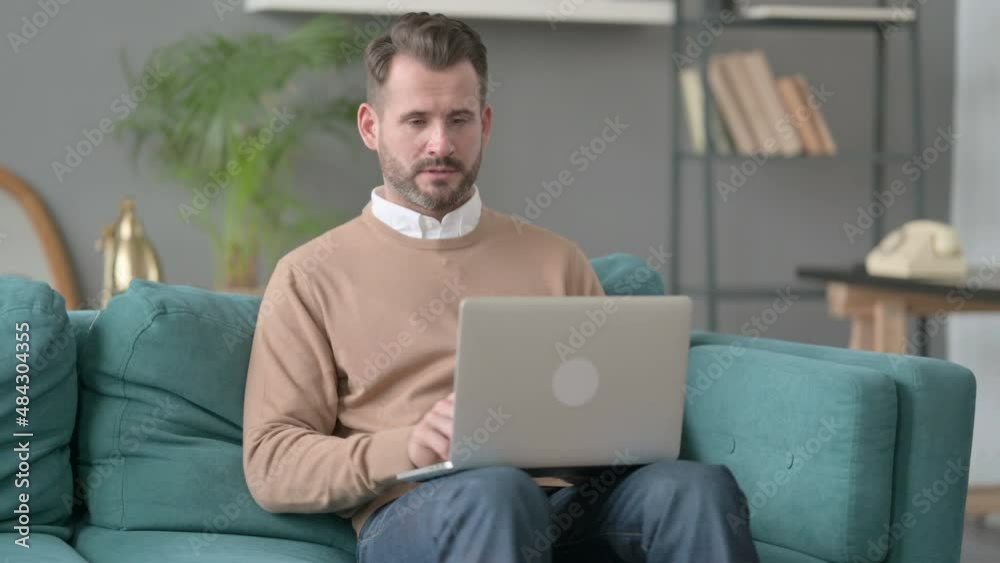 Man with Laptop Taking Nap on Sofa Man with Laptop Taking Nap on Sofa