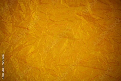 Crumpled gold paper recycling background.