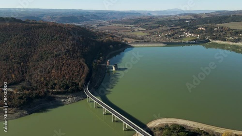 Aerial view of vehicles driving on the highway along Corbara lake (Lago di Corbara), Baschi, Terni, Italy. photo