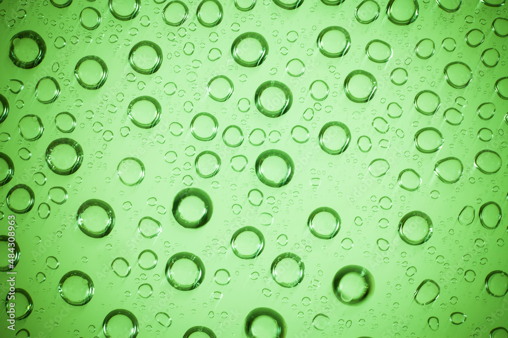 Water bubble on green glass.