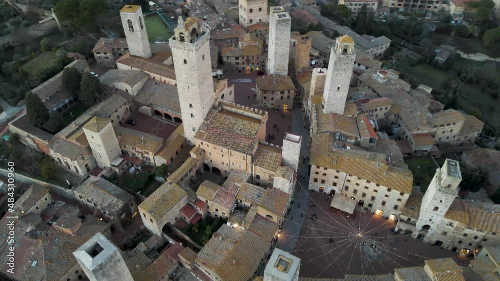 Aerial view of San Gimignano, a small old town with medieval tower at sunset, Siena, Tuscany, Italy. Aerial view of San Gimignano, a small old town with medieval tower at sunset, Siena, Tuscany, Italy.