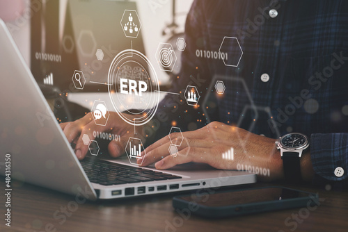 Businessman using a computer to Enterprise Resource Management ERP software system for business resources plan presented in modern graphic interface showing future technology to manage company.