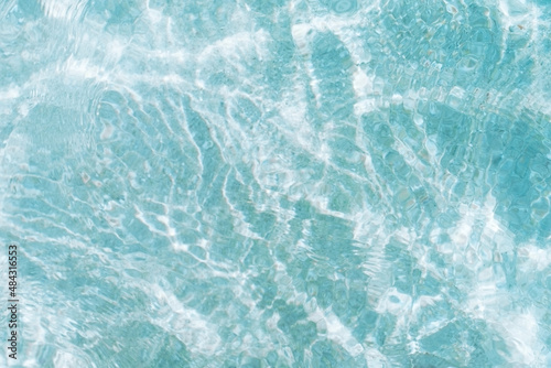 Small waves in the pool reflect the glare of the sun