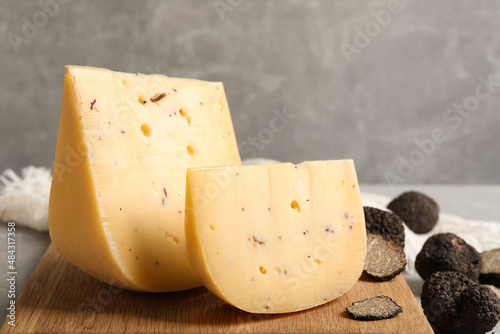 Delicious cheese and fresh black truffles on table photo