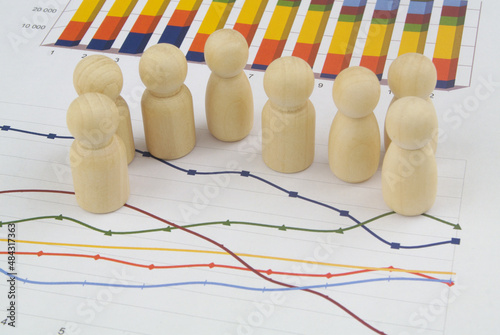 Management, demography and statistics concept. People figures on financial graphs close up. photo