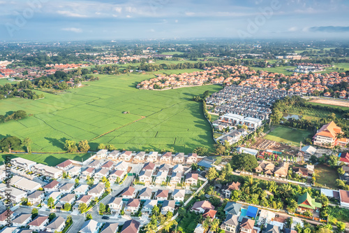 Land or landscape of green field in aerial view. Include agriculture farm, house building, village. That real estate or property. Plot of land to housing subdivision, development, sale or investment.

