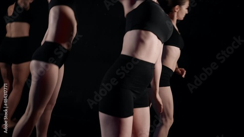 four modern ballerinas are rehearsing in dance class, dancing contemporary choreography