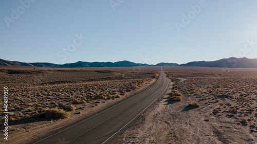 Road in Death Valley, California. Open highway beckoning the desert and mountains of Death Valley in California. © irengorbacheva