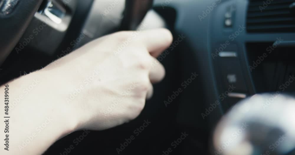 Female hand key starts a car turns on engine in close up slow motion Female hand key starts a car turns on engine in close up slow motion