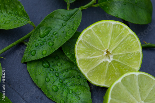 Fresh Cut Lime On Wet Dark Stone Close-up