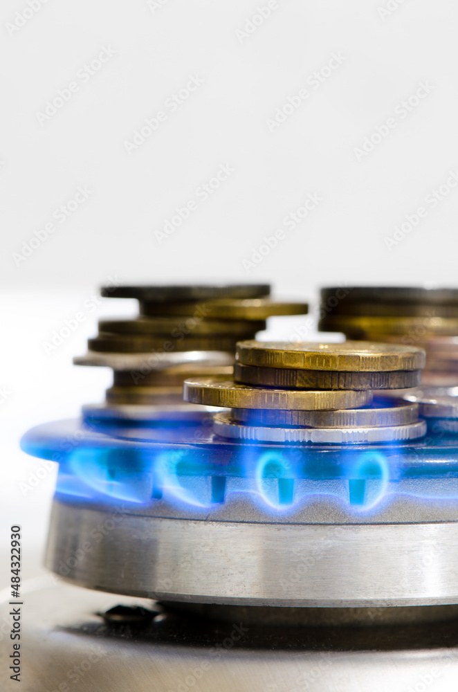 The money is on a lit gas burner. The concept of expensive natural gas. Copy cpace The money is on a lit gas burner. The concept of expensive natural gas. Copy cpace