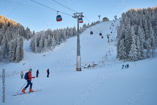Ski tourer woman ascending mild slope photo