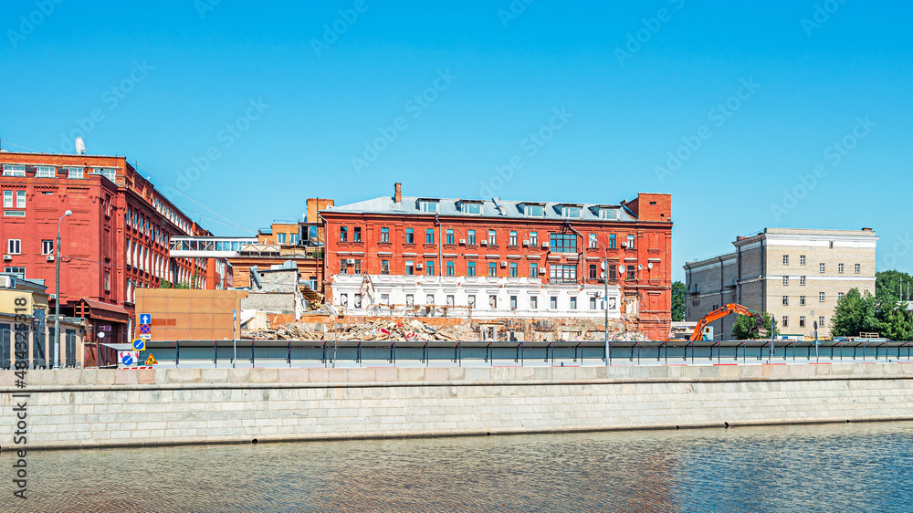 Dismantling a building on Bolotnaya Embankment in front of the Krasny Oktyabr confectionery in Moscow, Russia