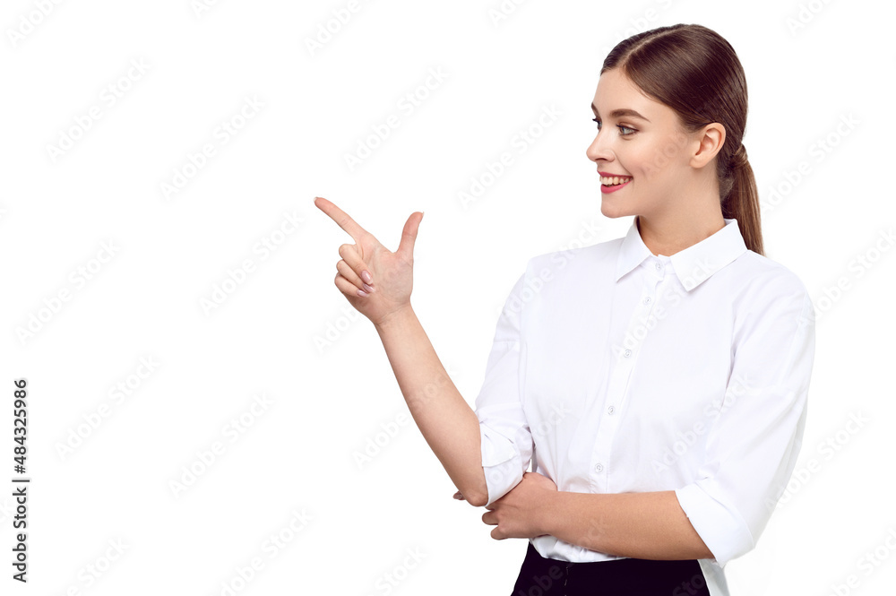 Young caucasian woman in white shirt pointing finger but product advertisement on white isolated background and smiling Young caucasian woman in white shirt pointing finger but product advertisement on white isolated background and smiling