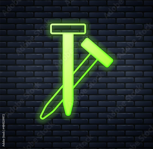 Glowing neon Metallic nails icon isolated on brick wall background. Vector