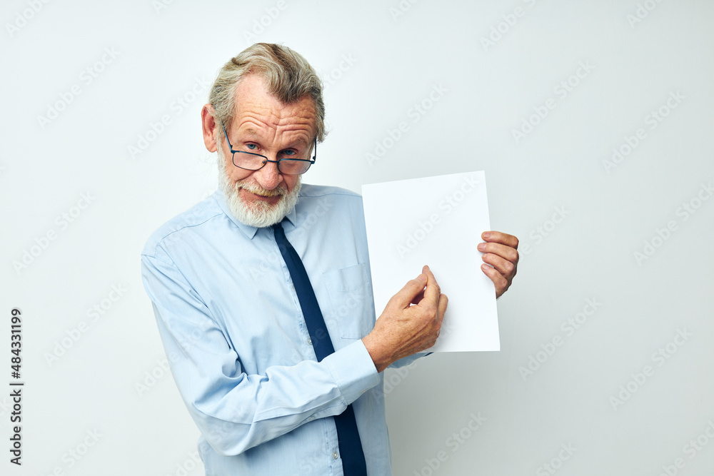 Portrait elderly man holding documents with a sheet of paper cropped view Portrait elderly man holding documents with a sheet of paper cropped view