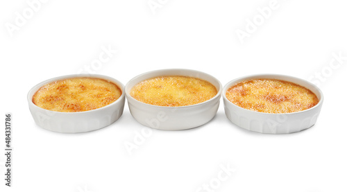 Delicious creme brulee in ceramic ramekins on white background