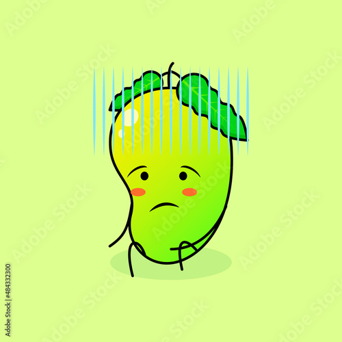 cute mango character with hopeless expression and sit down. green and orange. suitable for emoticon, logo, mascot and icon