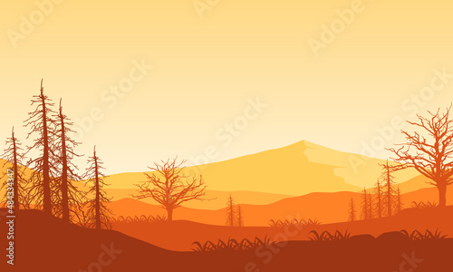 Realistic view of mountains during the day with dry tree silhouettes around