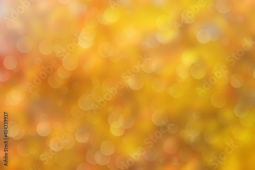 Abstract light yellow and orange blurred background with boke effect