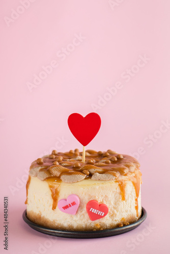 Valentine's day concept. Small bento cheesecake decorated with small hearts topper. Copy space