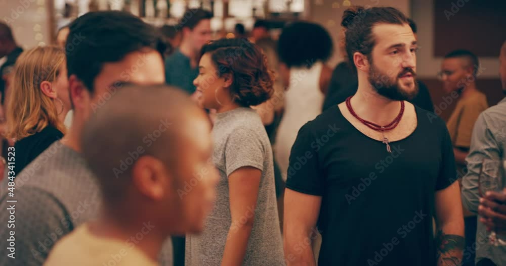 Group of diverse people happy smiling talking holding glasses drinking having fun at a party at a club.