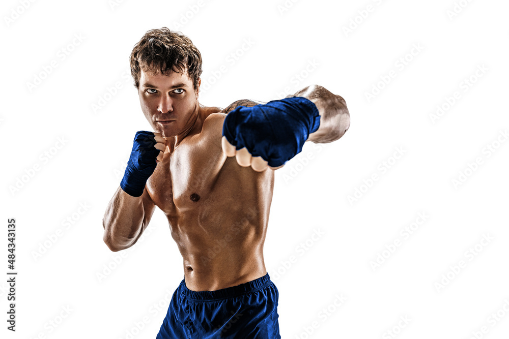 Studio shot of aggressive boxer who training, practicing swing on white background. Blue sportswear