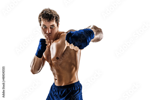 Studio shot of aggressive boxer who training, practicing swing on white background. Blue sportswear