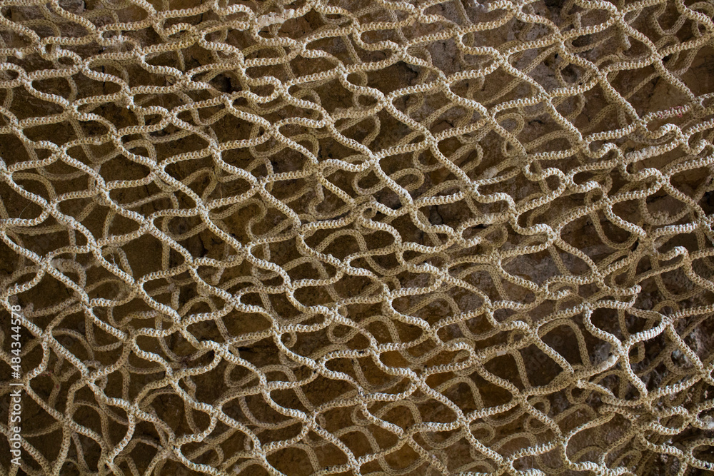 evocative image of fishermen net texture
evocative image of fishermen net texture