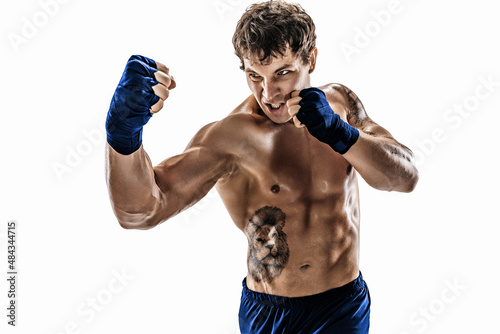 Portrait of aggressive boxer who training, practicing uppercut on white background. Blue sportswear