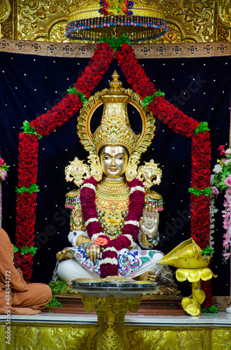 Lord Swaminarayan idol closeup inside the temple at Swaminarayan temple, Nilkanthdham, Poicha, Gujarat, India photo