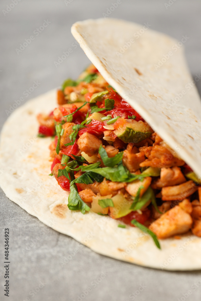 Tasty taco on grey textured background, close up Tasty taco on grey textured background, close up