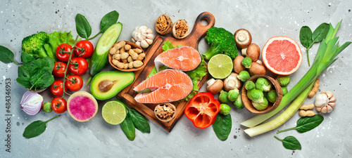 Foods good for the heart: nuts, salmon, avocados, spinach, mushrooms, berries. On a stone background. Top view.