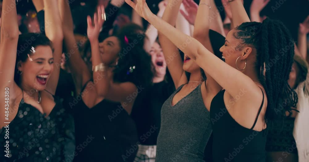 A fun night out no one would ever forget.  Group of beautiful young women celebrating and dancing at a party with friends. Diverse crowd having fun at a festival, concert, party, or rave