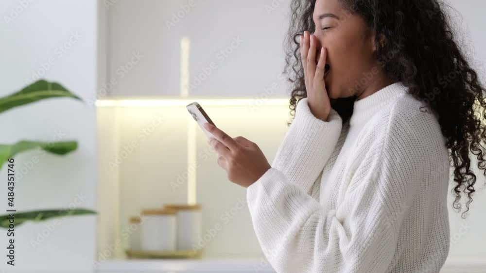 African American Girl using smartphone at home pressing finger, reading social media internet, typing text or shopping online Mobile phone in two black hands African American Girl using smartphone at home pressing finger, reading social media internet, typing text or shopping online Mobile phone in two black hands