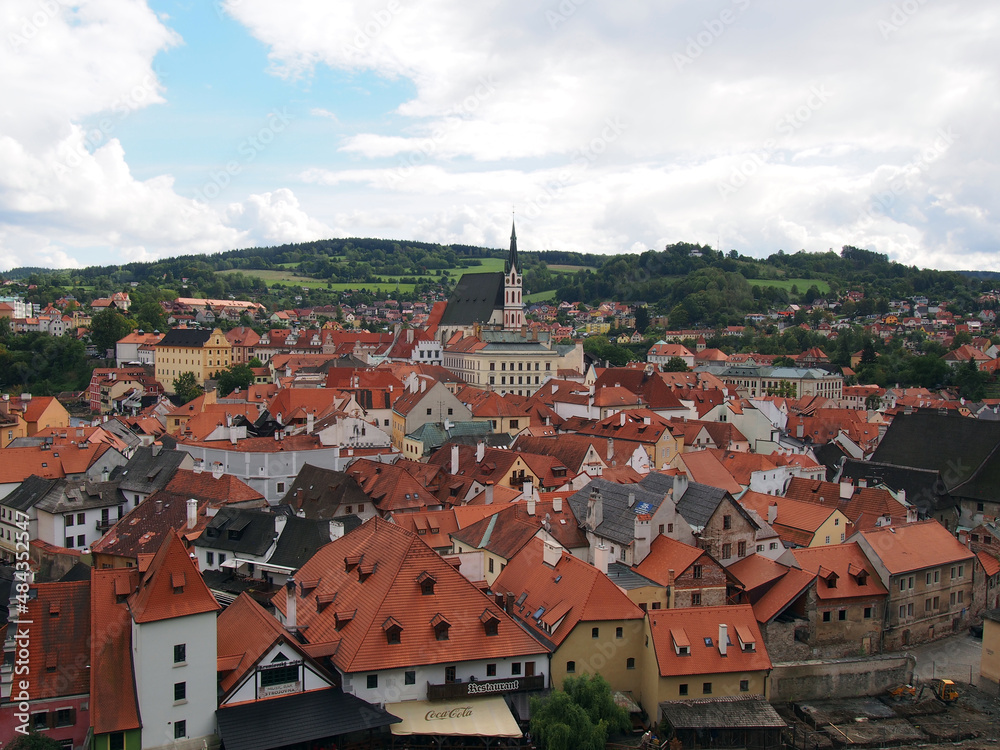 European historic city. View of the roofs of houses, in the distance we see the church tower and the castle.
