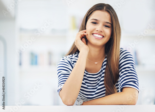 She has a million dollar smile. Portrait of an attractive young woman relaxing at home.