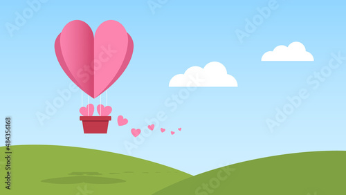 balloon with heart trail on blue sky with white cloud above green hill. love and care concept background for festive graphic design